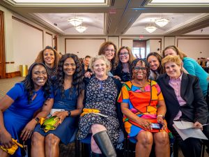 School of Nursing faculty sitting for a group photograph at the 2023 Pinning Ceremony.