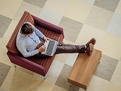 student typing on laptop