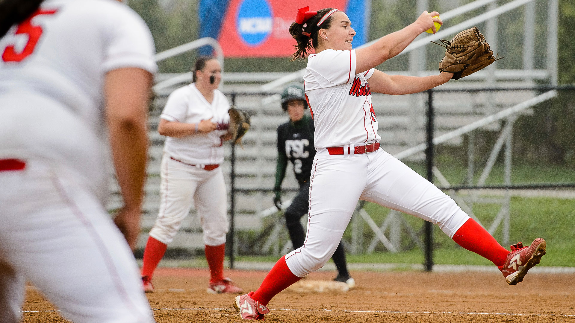Softball pitcher mid-throw