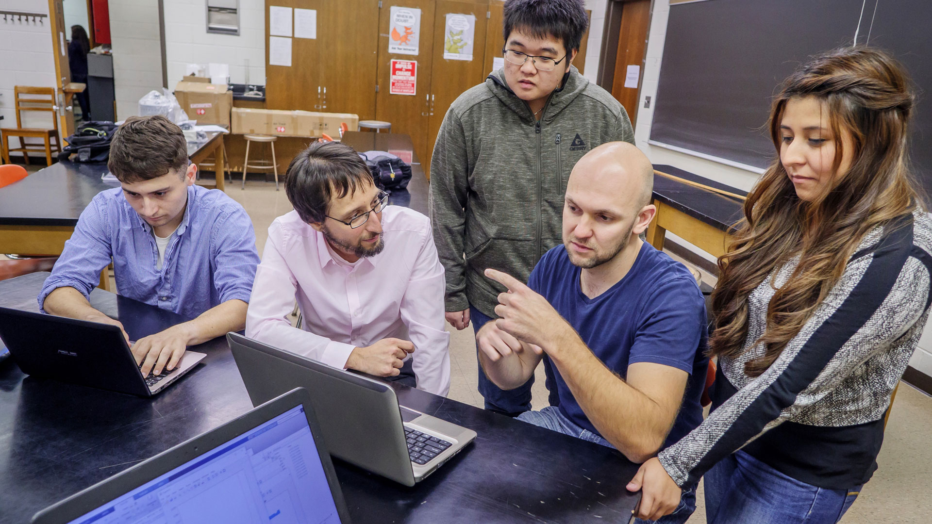 Professor Marc Favata and students reviewing data