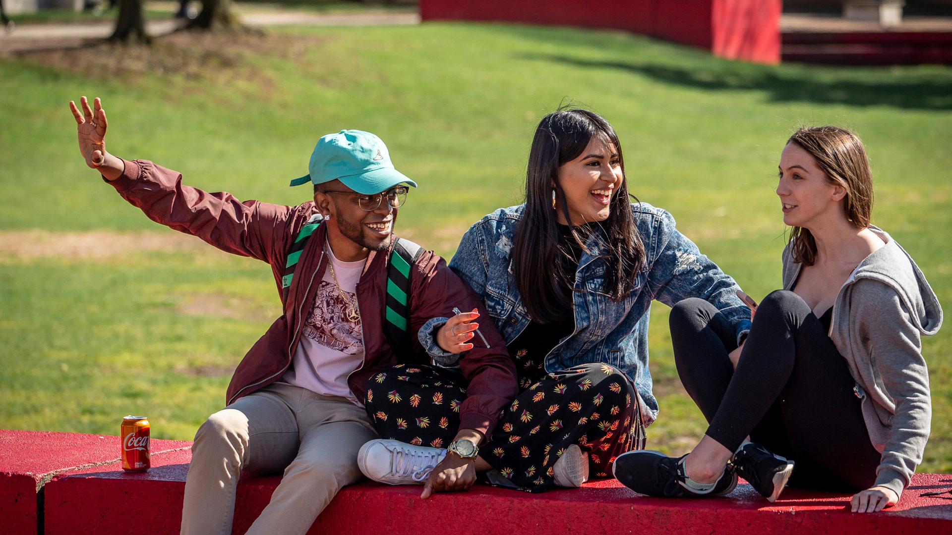 Students on red wall in quad
