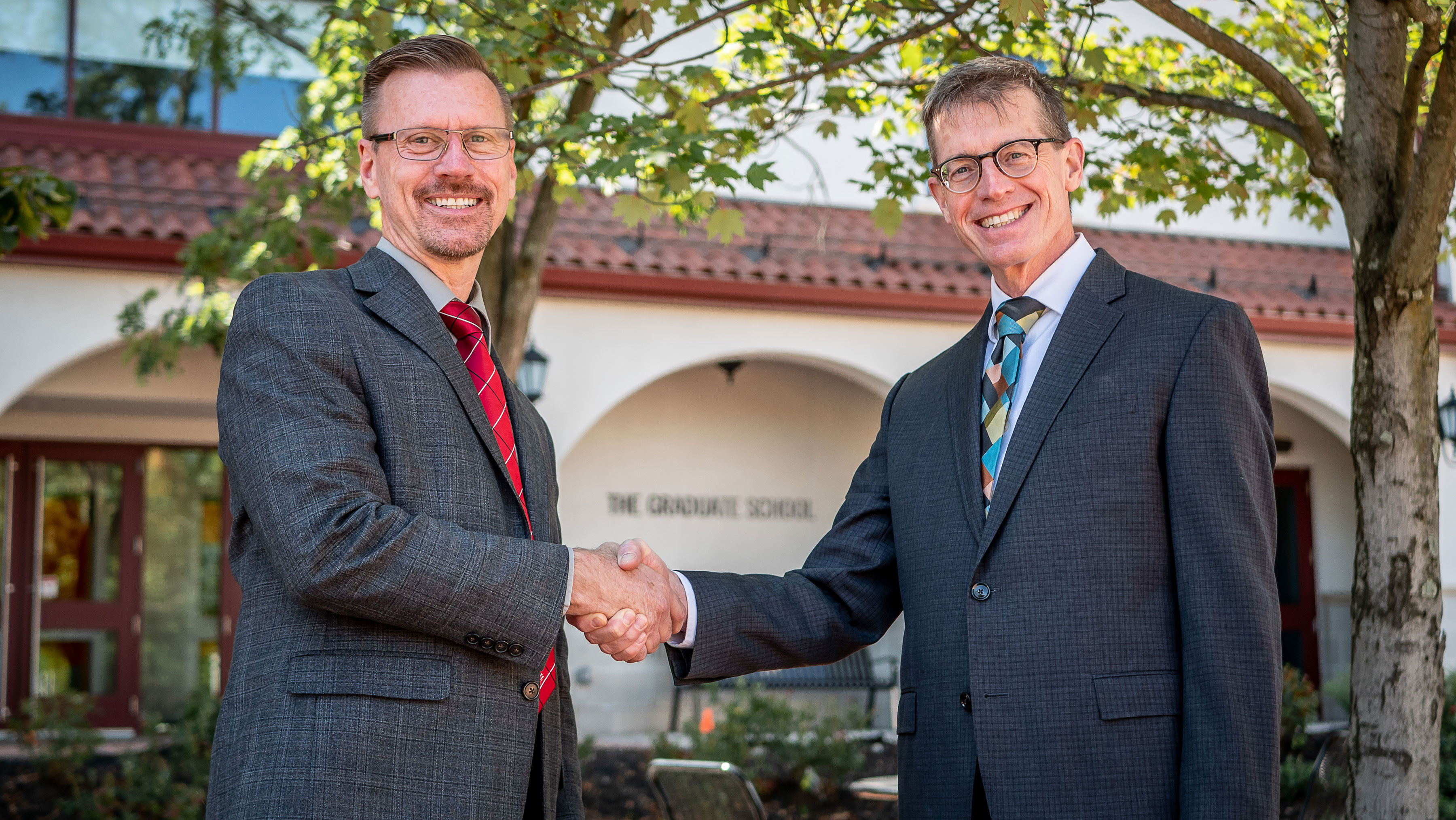 Scott Herness and Joe Brennan shaking hands