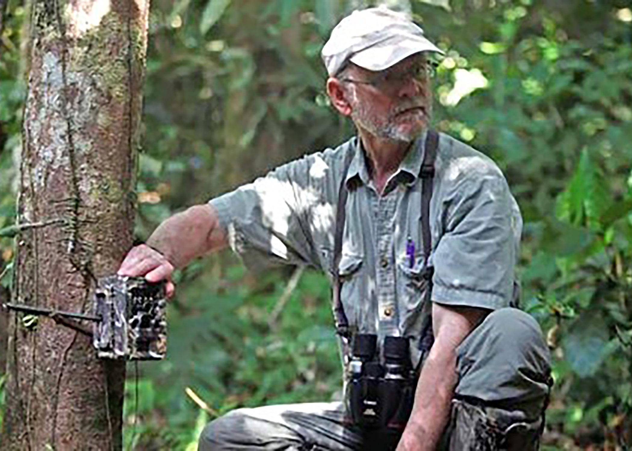 Greg Willis setting a camera trap