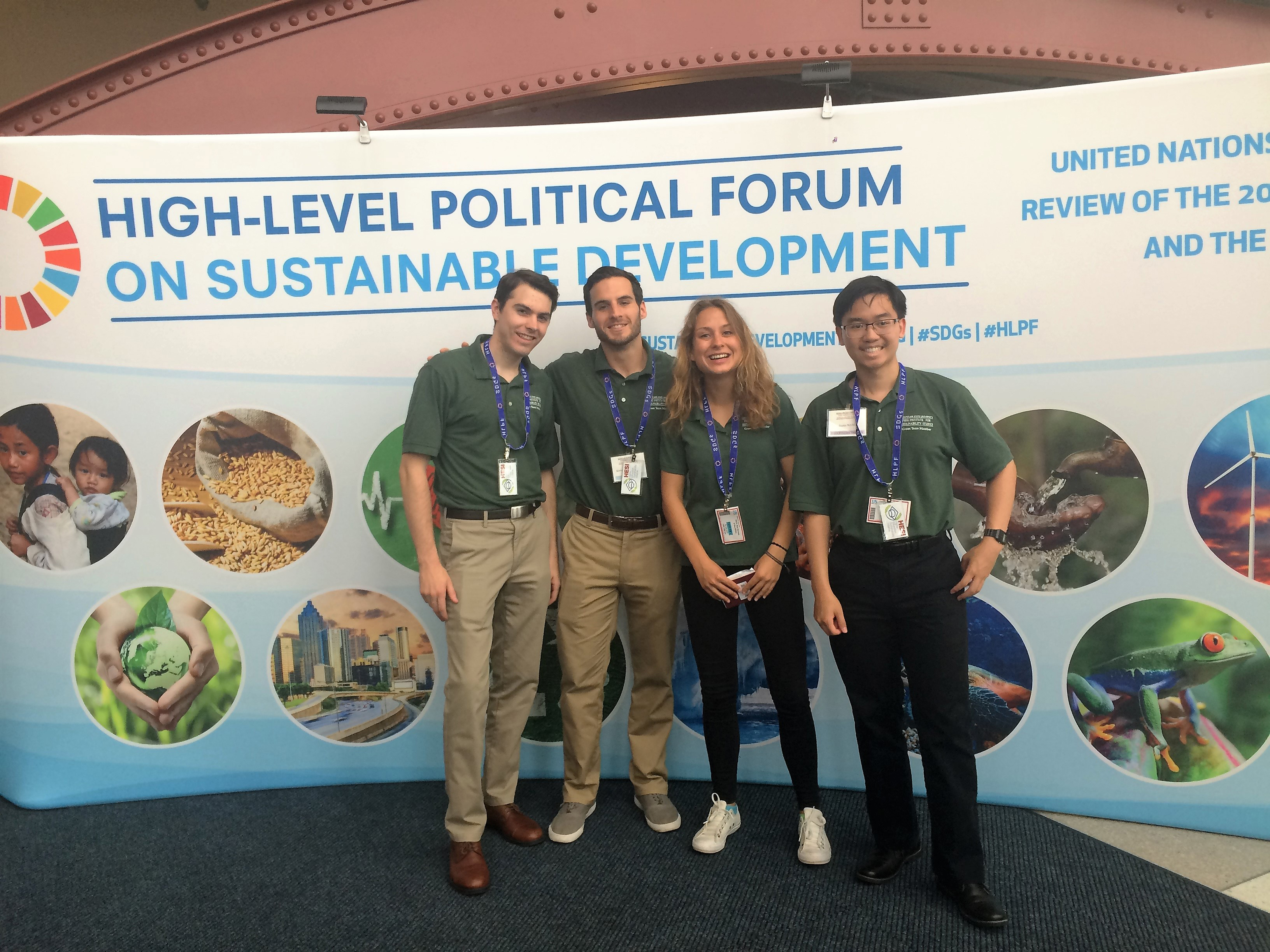 green team in front of sustainable development poster