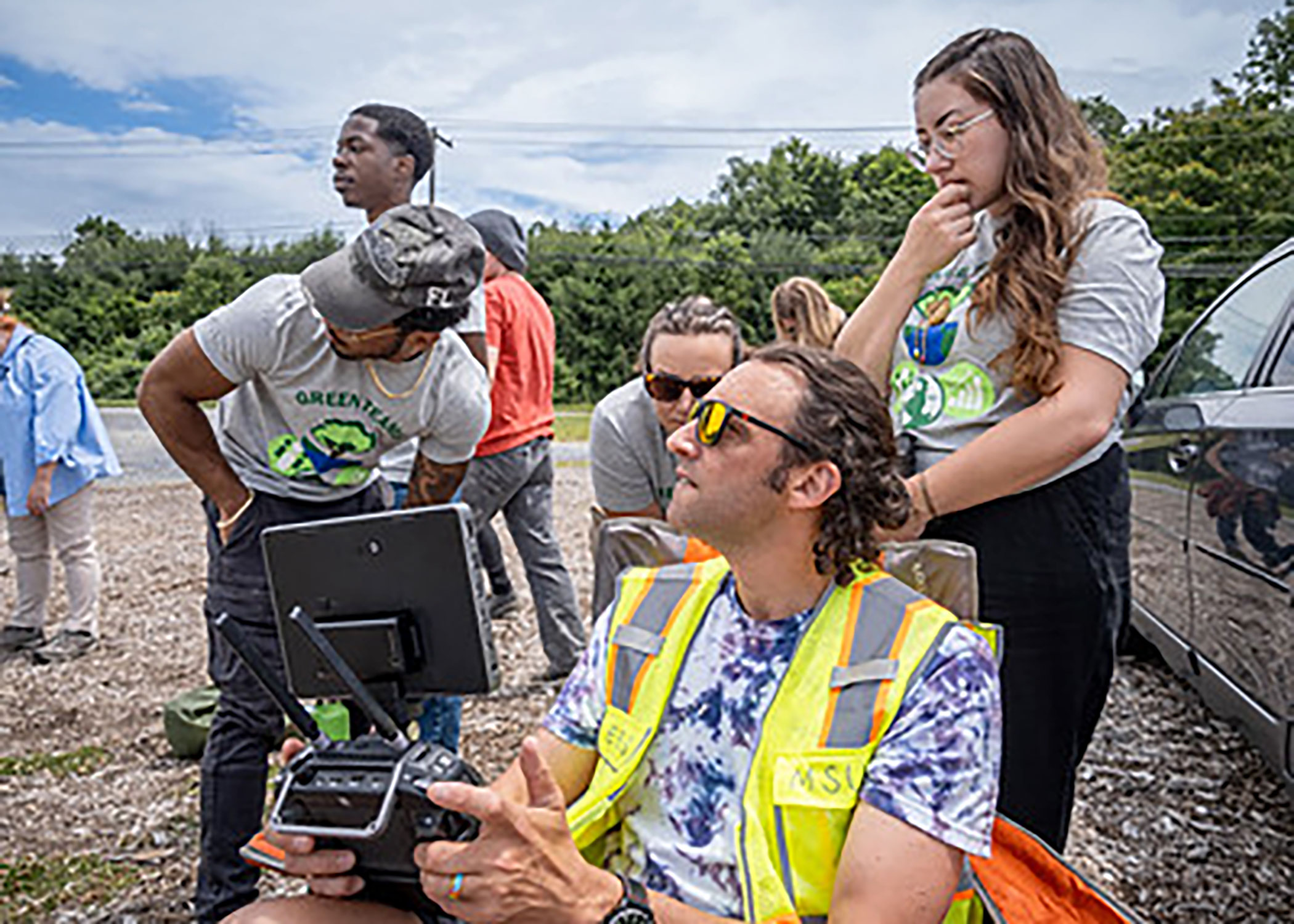 Green Team working with drone