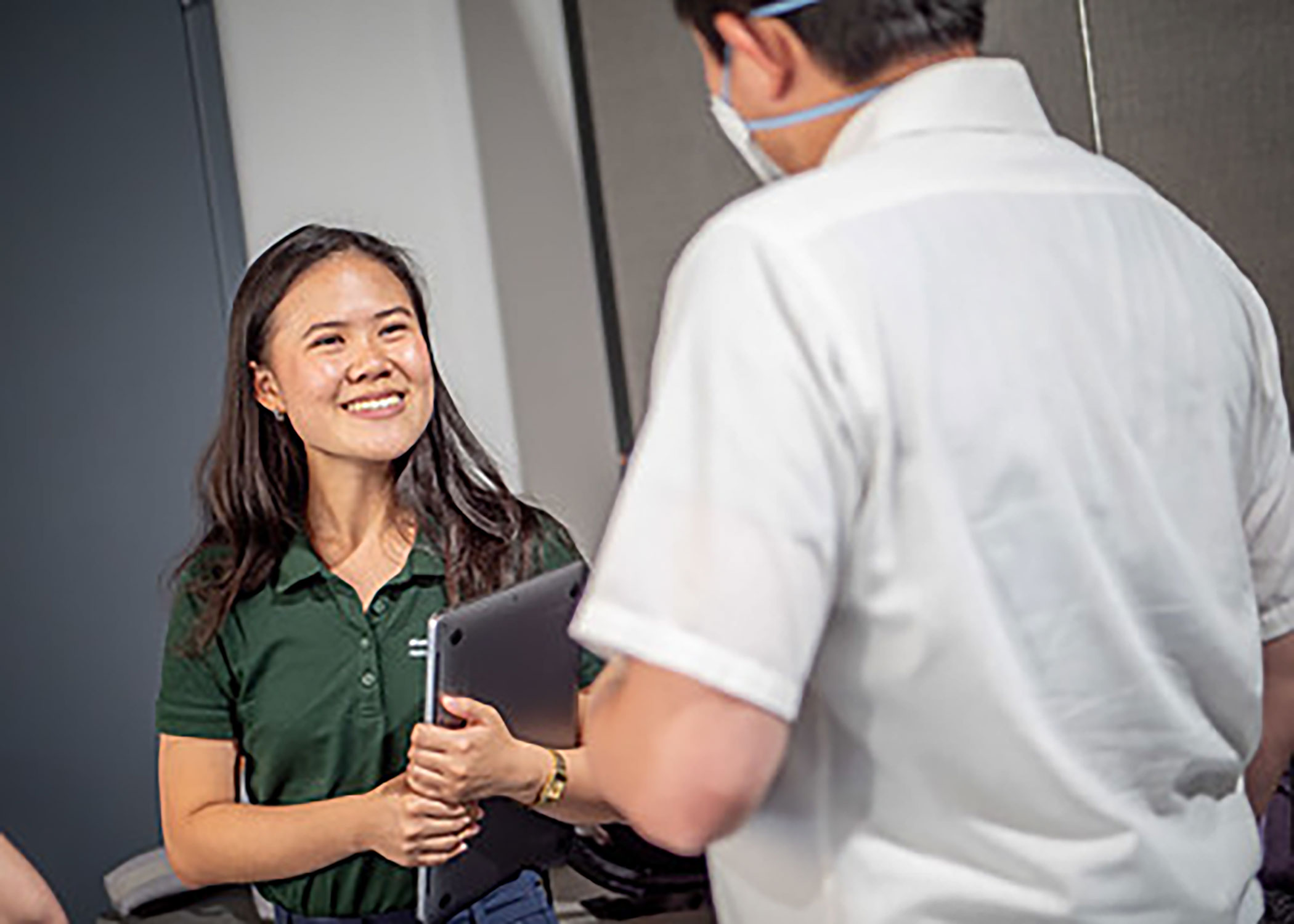 Green Team student talking with company rep