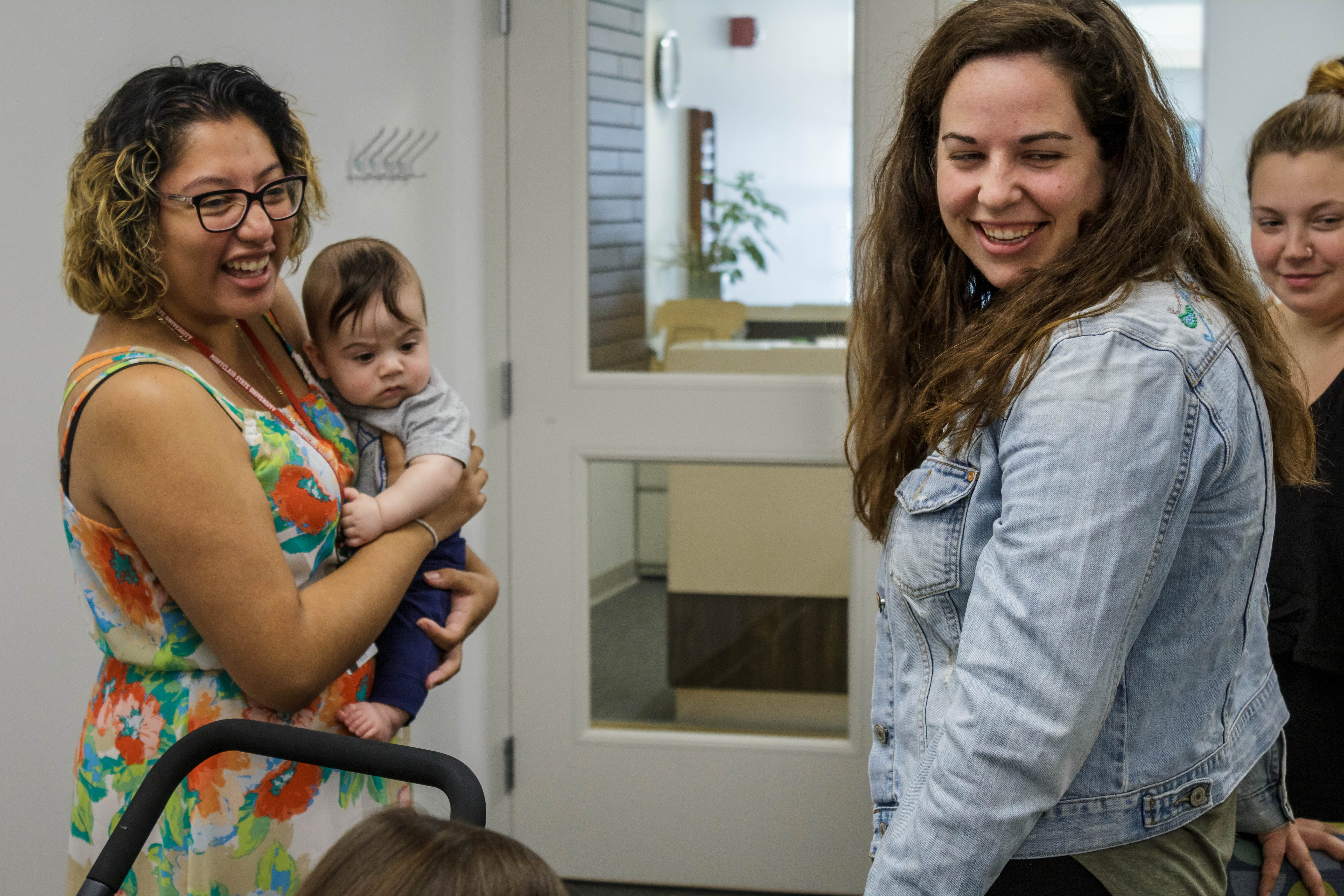 2 women and a baby smiling.