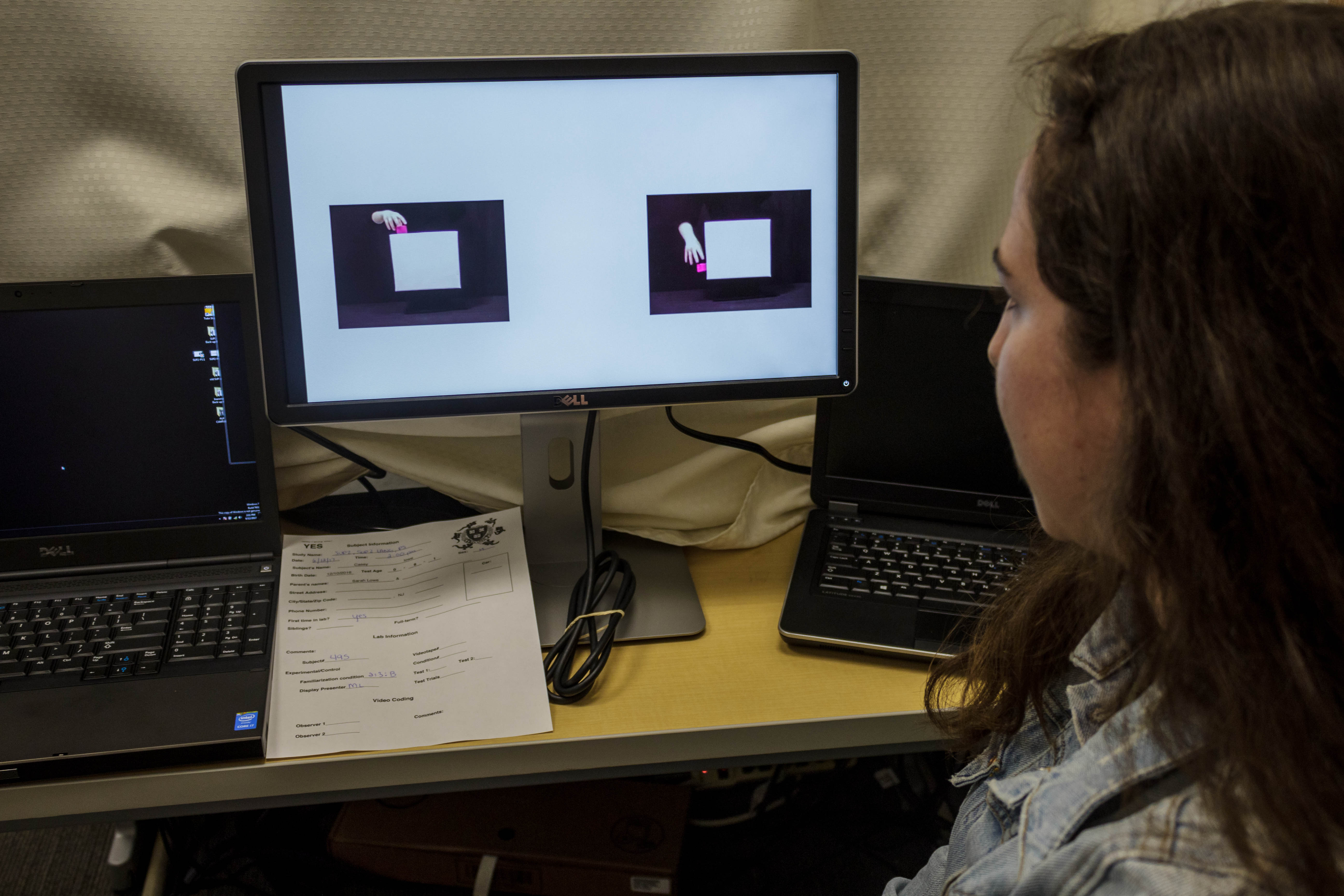 a young lady studying a video.