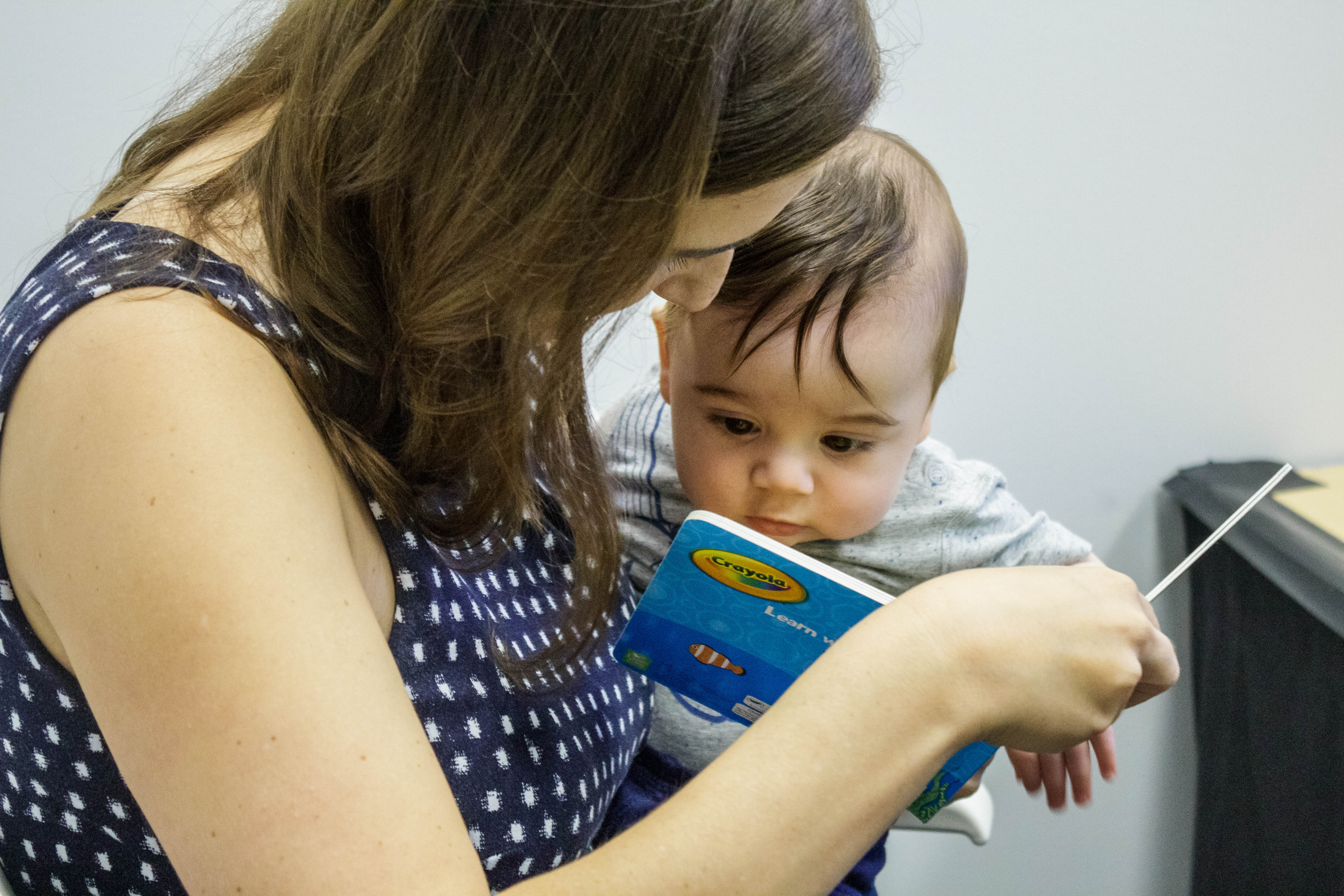 a mom reading to her baby.