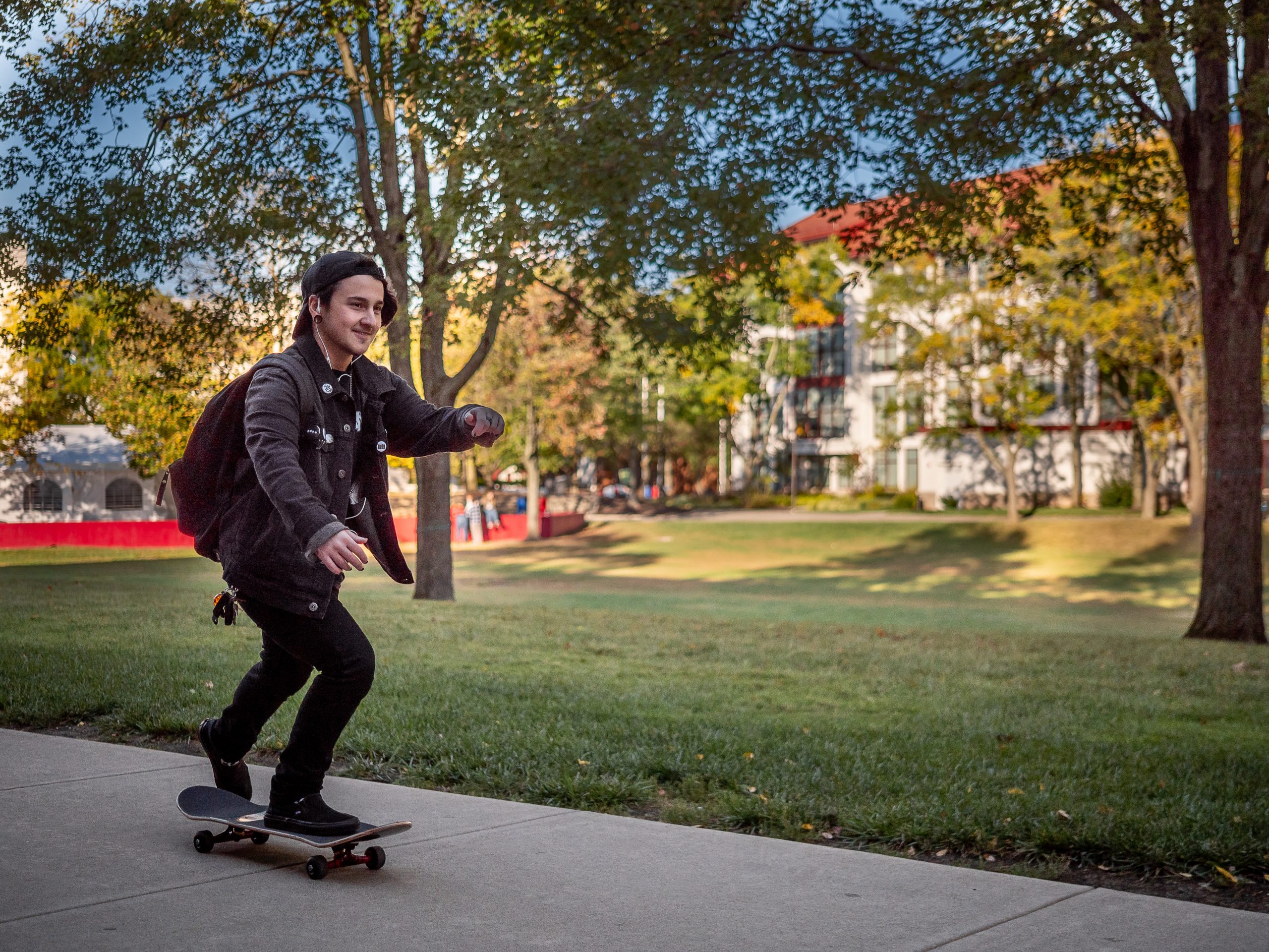 Student skateboarding across campus.