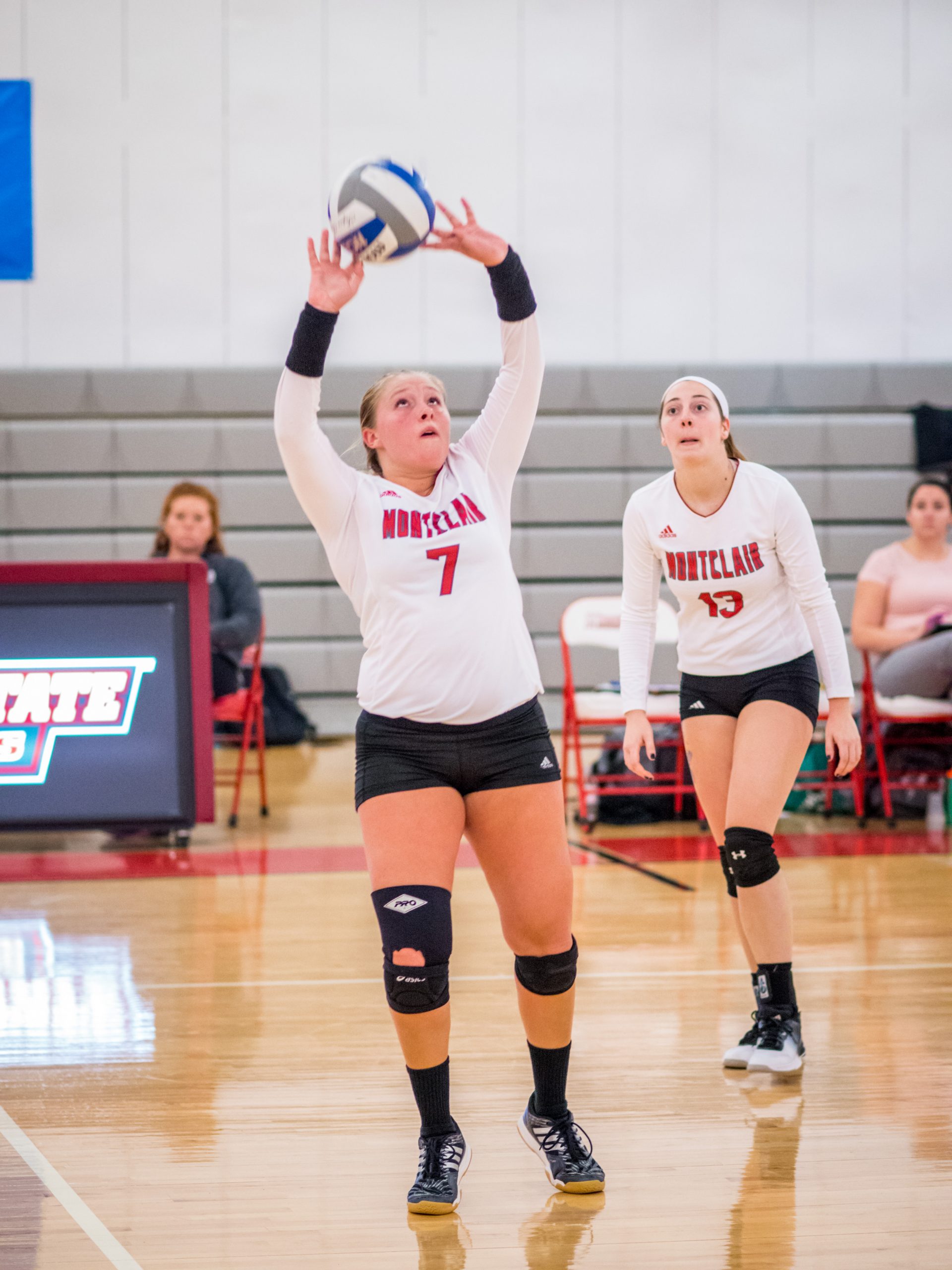 Montclair State University volleyball player hitting a ball.