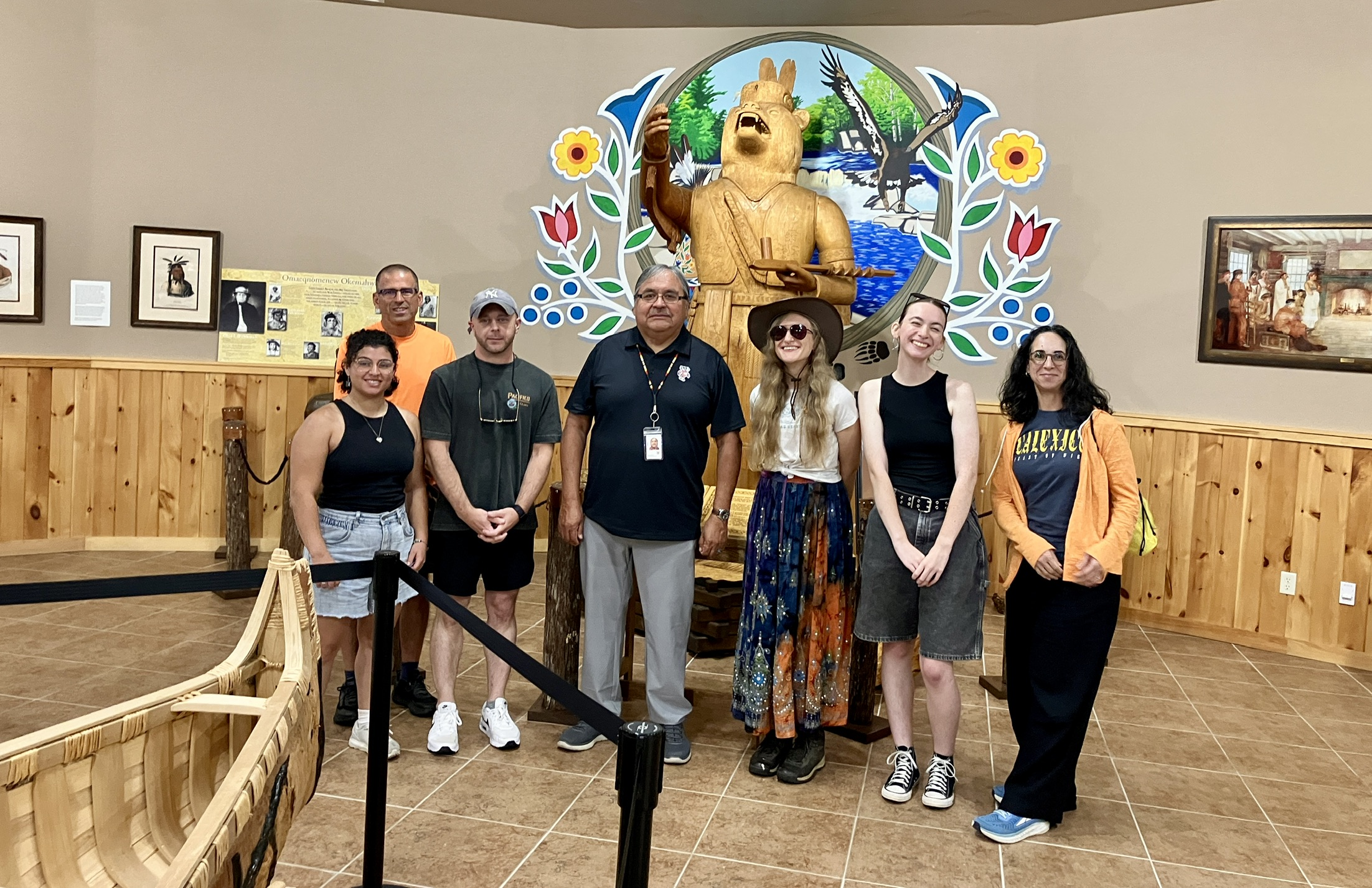 a group stands together in a Menominee Cultural Museum