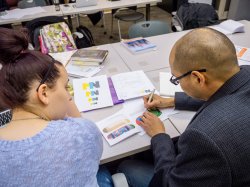 Photo of a student and professor in a visual communications class