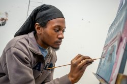 Student painting on canvas