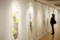 person in gallery viewing Chinese art