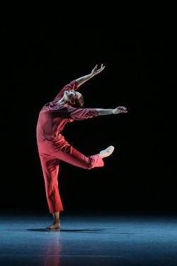 Montclair dance student in red costume performs on stage
