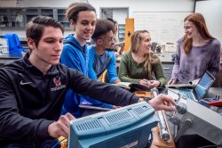 Students in a lab taking readings off an oscilloscope