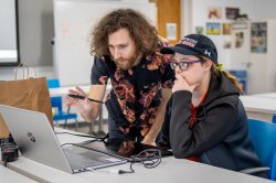 A college professor helps a student with a class project at Montclair State University.
