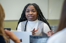 Students speaking at a table