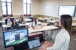 Student presenting at front of classroom