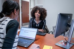 Students sitting across from each other at a desk