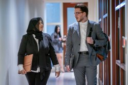 Two students walking down a hallway between classes