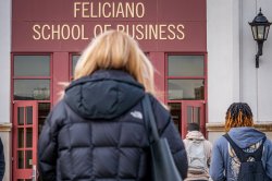 Student walking toward Feliciano School of Business