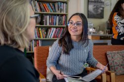 A student discusses plans for a new volunteer program with a community leader.