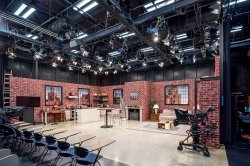 A television studio in Montclair State University, stage set shows a kitchen, fireplace and living room arrangement