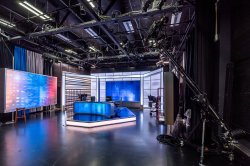 View of television studio A showing a newscaster desk in front of LED arches