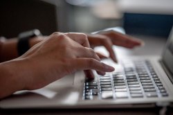 hands over a laptop keyboard