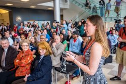 A student asks a question during a press conference at Montclair State University