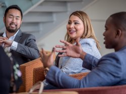 professionals talking in lounge chairs