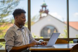 Graduate student on laptop studying