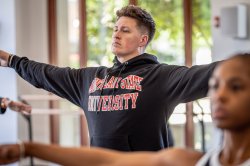 MFA Dance students in studio with arms outstretched