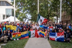 Students pose with flags of different Latin American nations.