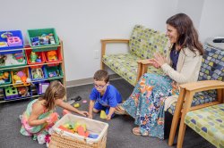 Adult watching two children play