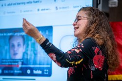 Instructor in front of screen