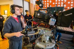 A student films a television broadcast at Montclair State University.
