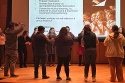 music education students in a circle on stage