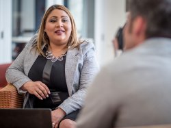 Montclair students in conversation, wearing professional attire