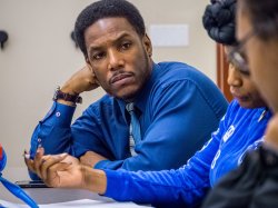 Student listening to his peers.