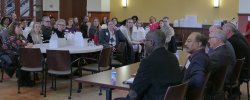 Picture of the audience looking toward the table of panelists from the event.