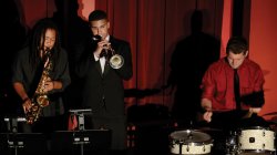 students in theater orchestra section playing saxophone, trumpet and drums