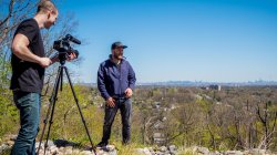 students shooting video on location overlooking NYC skyline