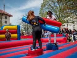 Two students playing in an inflatable jousting arena