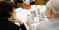 A couple of alums looking at yearbook.