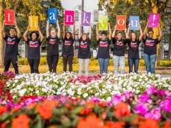 Students holding up letters spelling out thank you