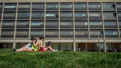 two students reading on the quad in front of Blanton Hall