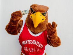 Rocky the Red Hawk holding up a twenty dollar bill.